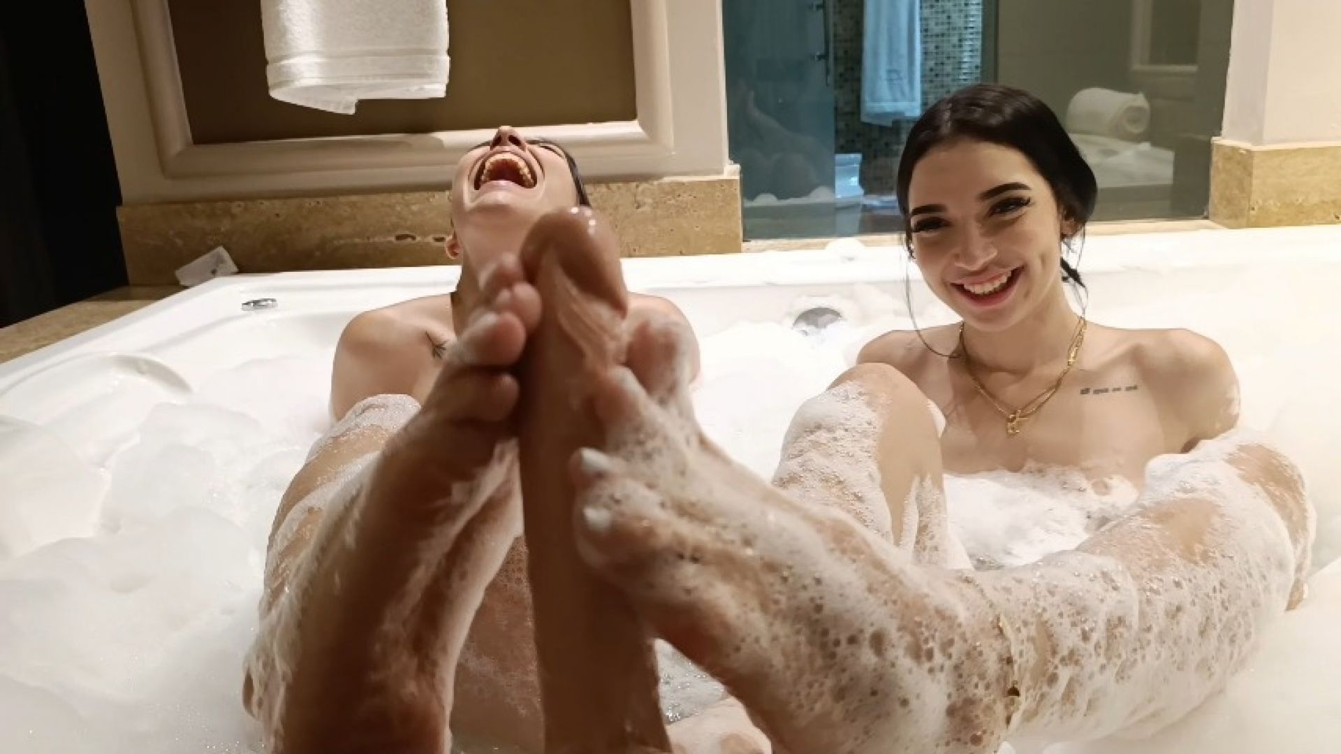 Lily_X:Two hot brunettes in a jacuzzi doing footjob