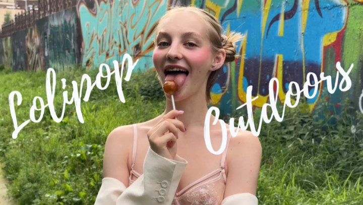LilyFate:Sucking a lollipop outdoors